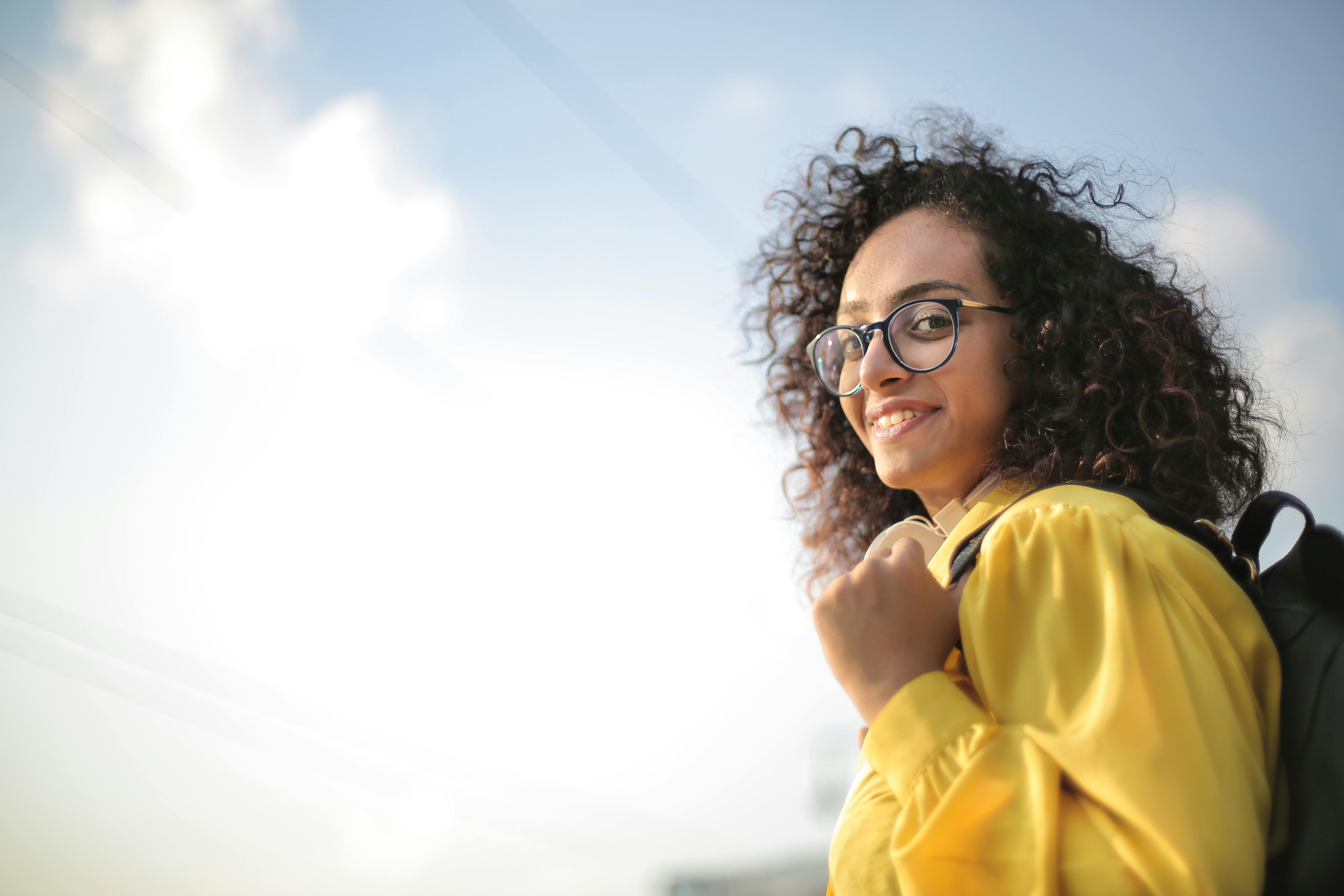 Woman Smiling Outside How to Respond to a Settlement Letter From a Law Firm